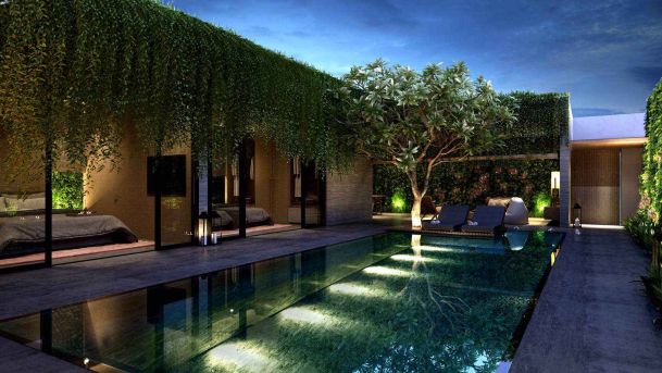 Modern courtyard with a swimming pool, lush greenery, and ambient lighting surrounding a contemporary home.