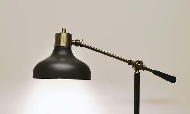 a black desklamp turned on