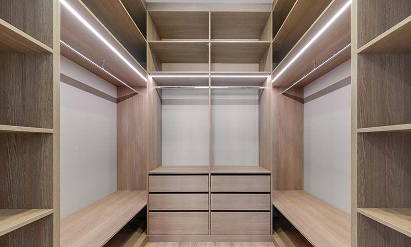 An empty closet with linear LED lighting